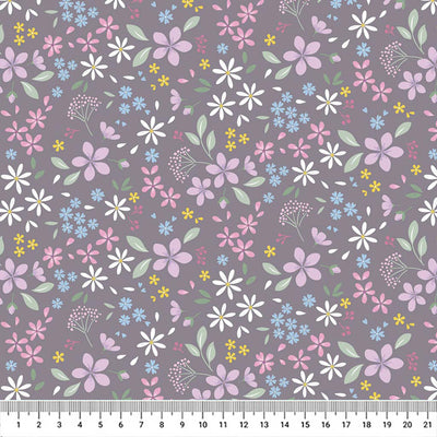 Pressed flowers printed on a grey cotton quilting fabric with a cm ruler