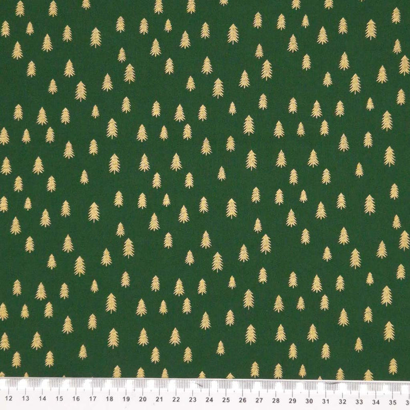 Gold trees with a metallic effect are printed on a quality, green, 100% cotton fabric with a cm ruler