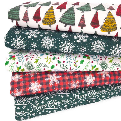 A fat quarter bundle of christmas designs including trees and snowflakes