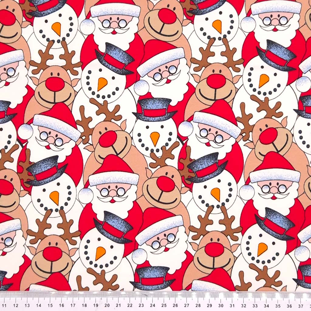 Santa, snowmen and reindeer printed on a christmas french terry fabric with a cm ruler