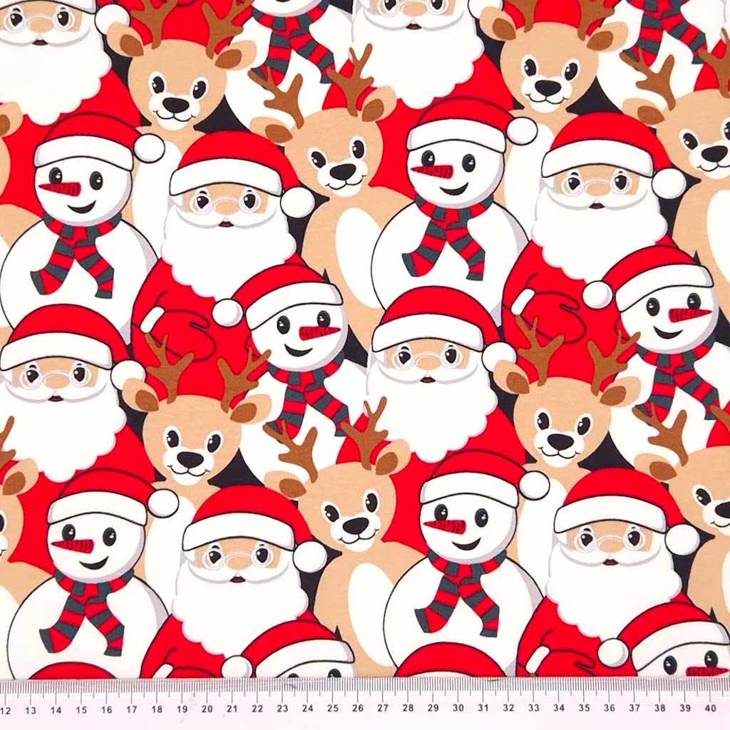 Santa, snowman and reindeer printed on a french terry christmas fabric with a cm ruler