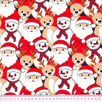 Santa, snowman and reindeer printed on a french terry christmas fabric with a cm ruler