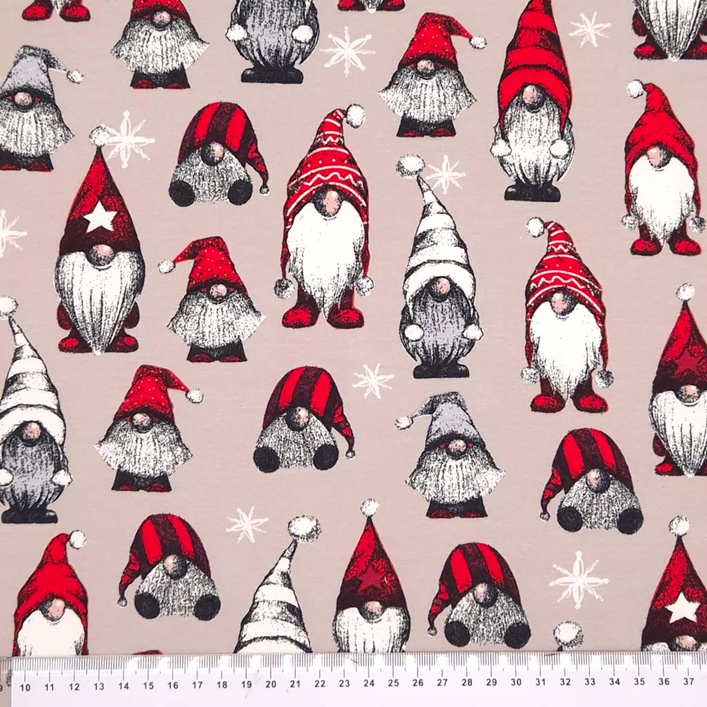 Christmas gonks printed on a beige french terry fabric with a cm ruler