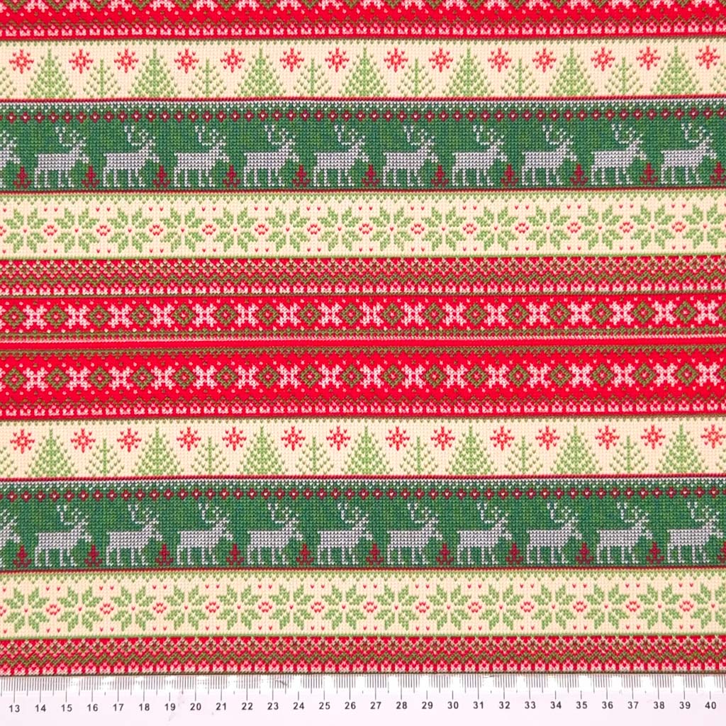 A striped scandinavian style christmas cotton jersey fabric with a cm ruler