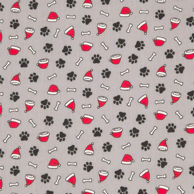 Doggy paws and santa hats printed on a grey polycotton fabric