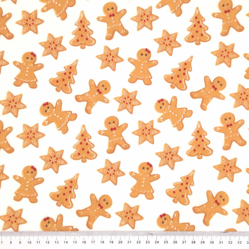 Gingerbread biscuits printed on a white polycotton fabric with a cm ruler