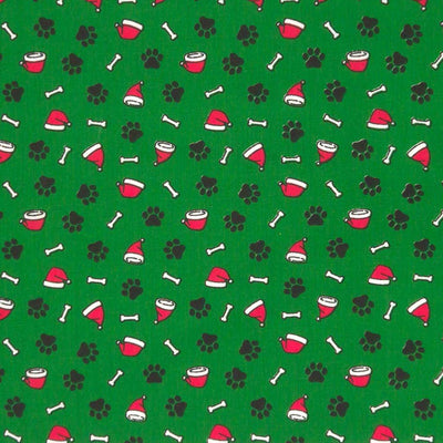 Doggy paws and santa hats printed on a green polycotton fabric