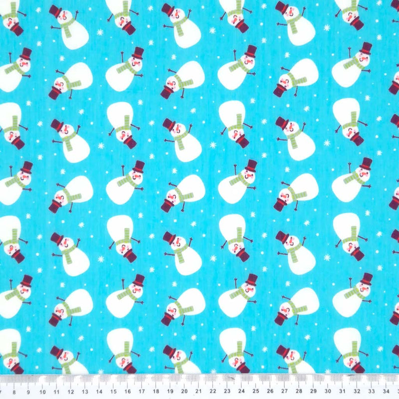 Snowmen printed on a blue polycotton fabric with cm rulers