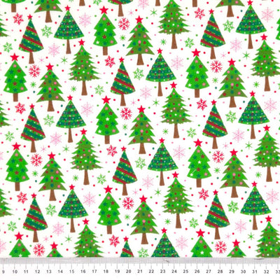 Colourful christmas trees printed on a white polycotton fabric with a cm ruler