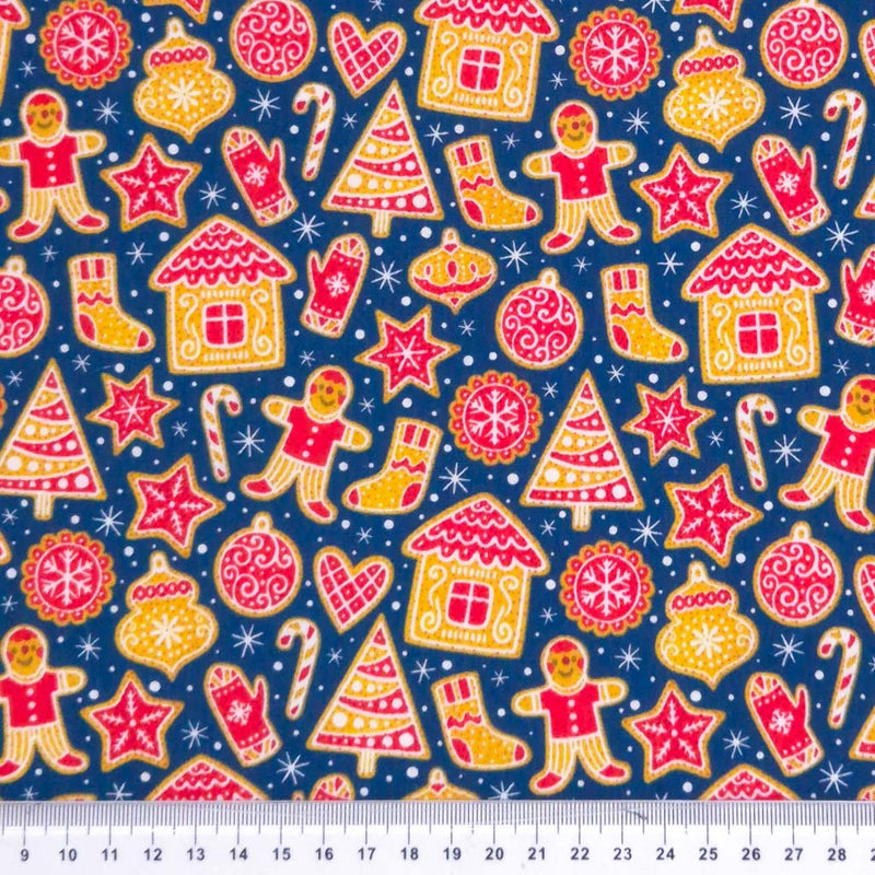 Gingerbread people and houses printed on a navy polycotton fabric with a cm ruler