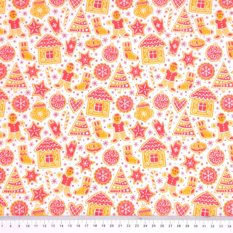 Gingerbread people and houses printed on a white polycotton fabric with a cm ruler