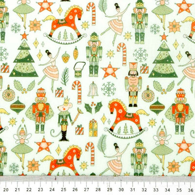 Christmas-themed fabric pattern with toys, trees, and stars on a white polycotton.