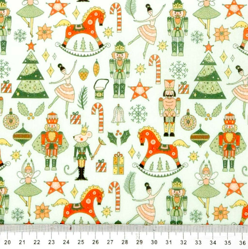 Christmas-themed fabric pattern with toys, trees, and stars on a white polycotton.