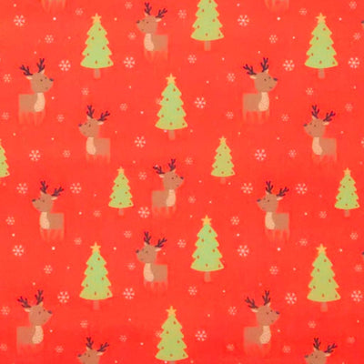 Pattern of reindeer, Christmas trees, and snowflakes on a red polycotton fabric