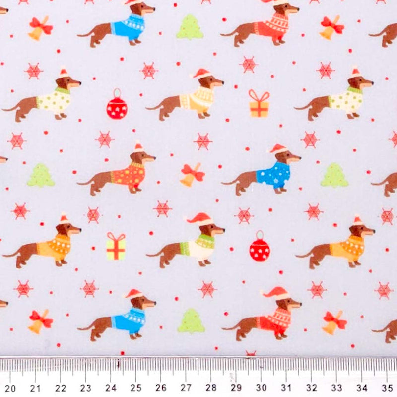 Pattern of small dogs in colorful sweaters and Christmas decorations on a light gray background with a ruler at the bottom.