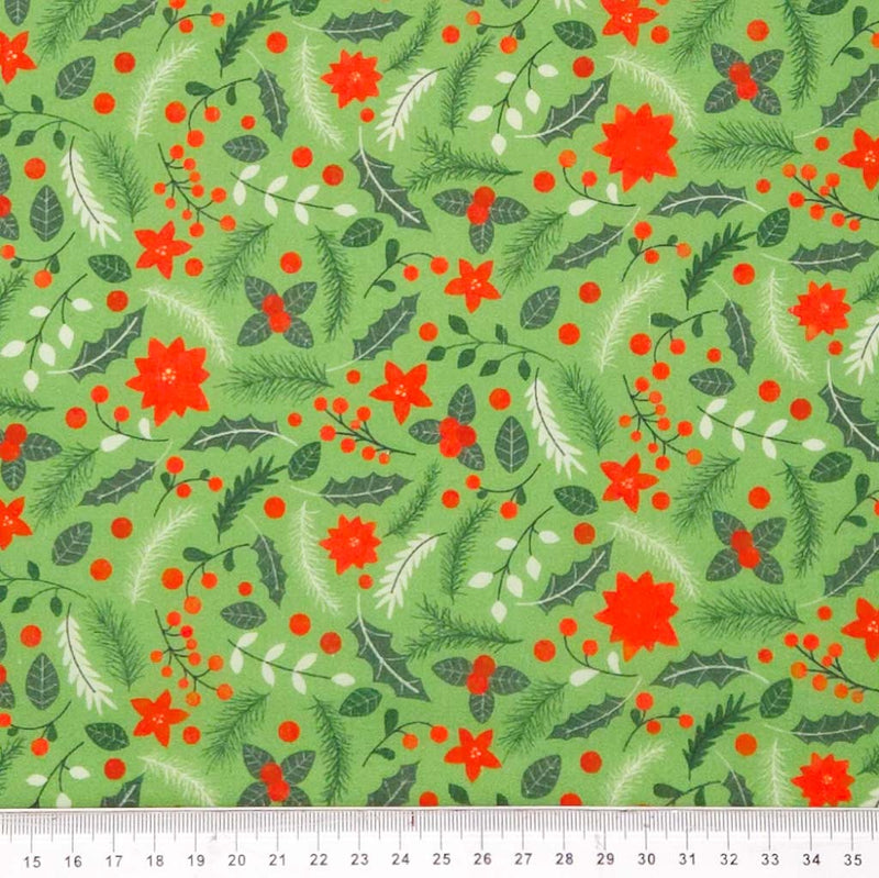 Christmas-themed fabric pattern with red flowers, green leaves, and berries on a green polycotton fabric.