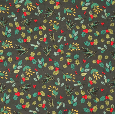 A classic christmas holly design on bottle green cotton fabric