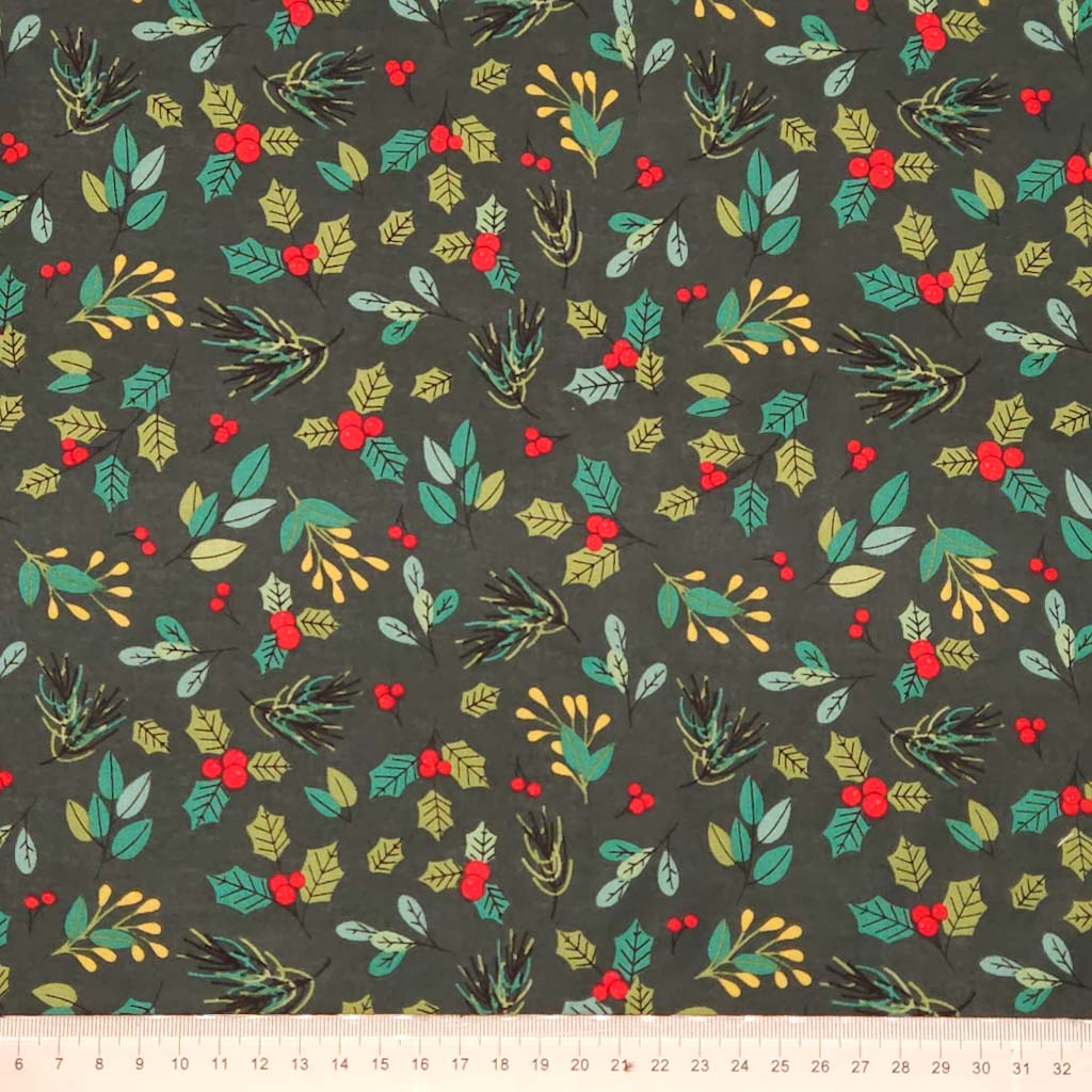 Festive fabric pattern with green leaves, red berries, and gold accents on a dark green cotton fabric