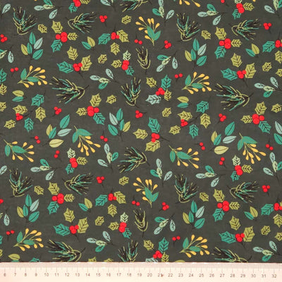 Festive fabric pattern with green leaves, red berries, and gold accents on a dark green cotton fabric