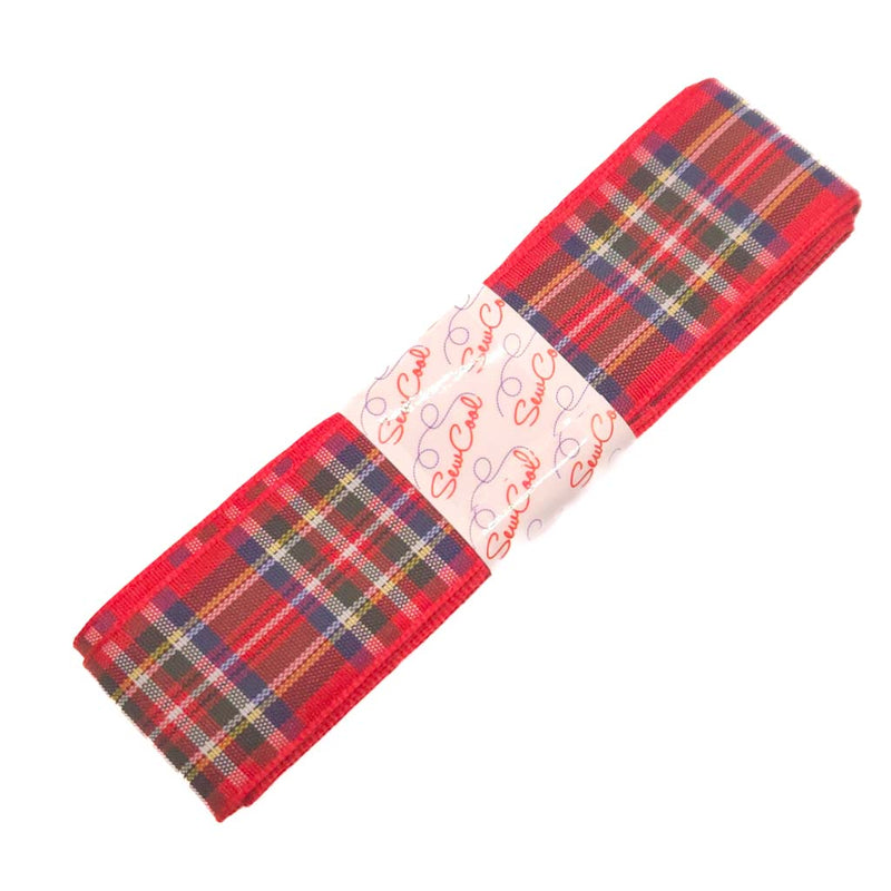 Red tartan fabric ribbon with a white label on a white background