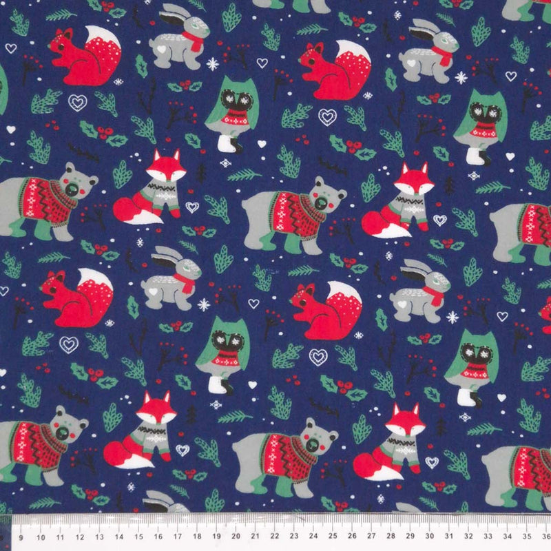 Festive woodland animals printed on a navy polycotton fabric with a cm ruler