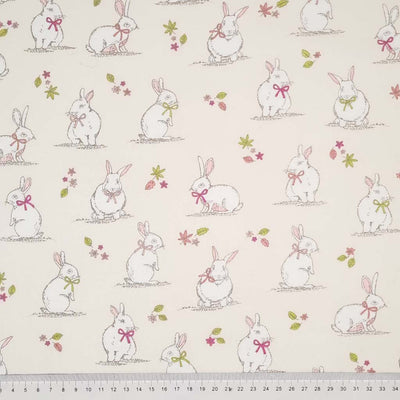 Cute bunnies printed on a cream cotton fabric with a cm ruler
