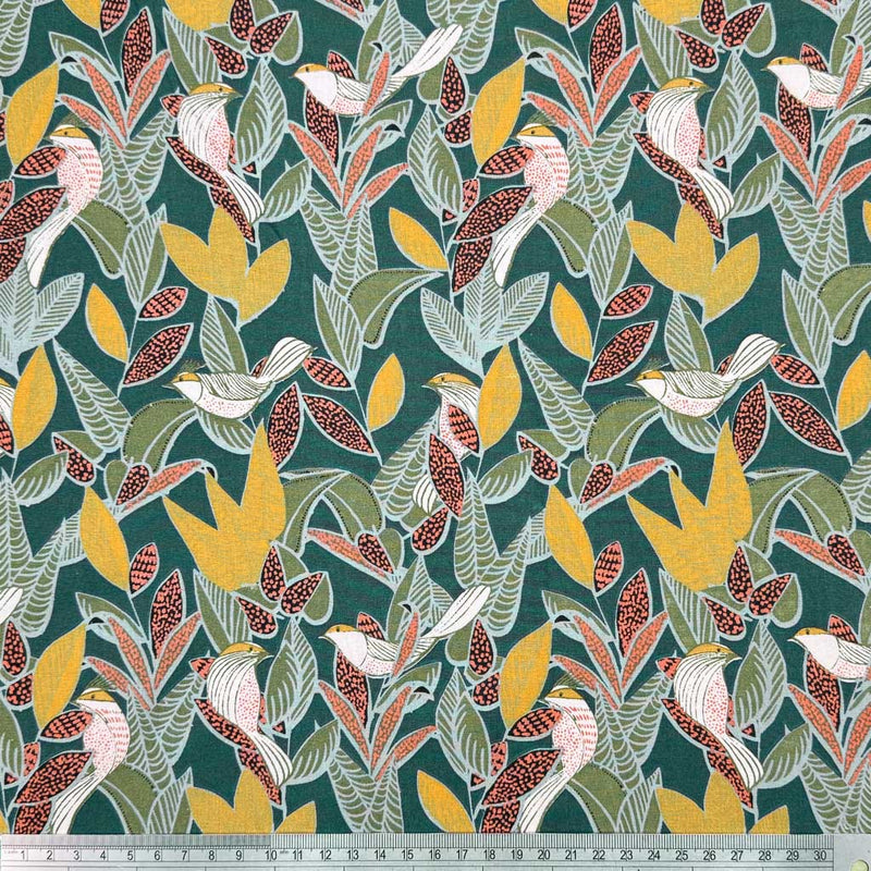 A floral design of birds and vines and birds in deep shades of yellow and burgundy with complimentary black and white details, on a forest green background with a cm ruler