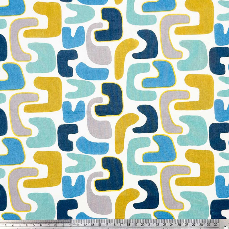 Abstract shapes of blue and yellow on a contrasting, bold white background printed on an 100% cotton fabric with a cm ruler