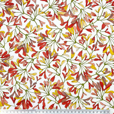 Mini leaves in autumnal shades of red, pink and yellow, printed on an 100% cotton fabric with a cm ruler