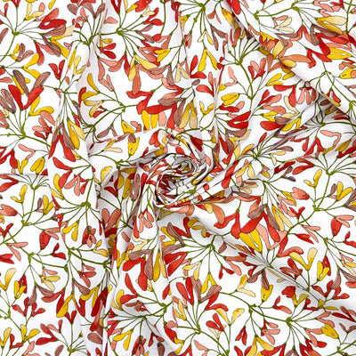 Mini leaves in autumnal shades of red, pink and yellow, printed on an 100% cotton fabric