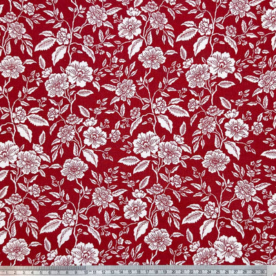 White flowers on a deep wine background; printed on a 100% cotton fabric with a cm ruler