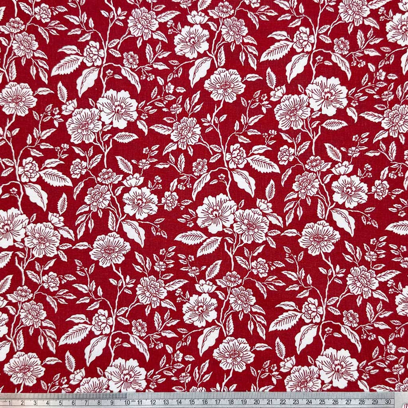 White flowers on a deep wine background; printed on a 100% cotton fabric with a cm ruler