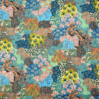 A bright fabric with multicoloured flower displays printed on a dark dressmaking cotton fabric