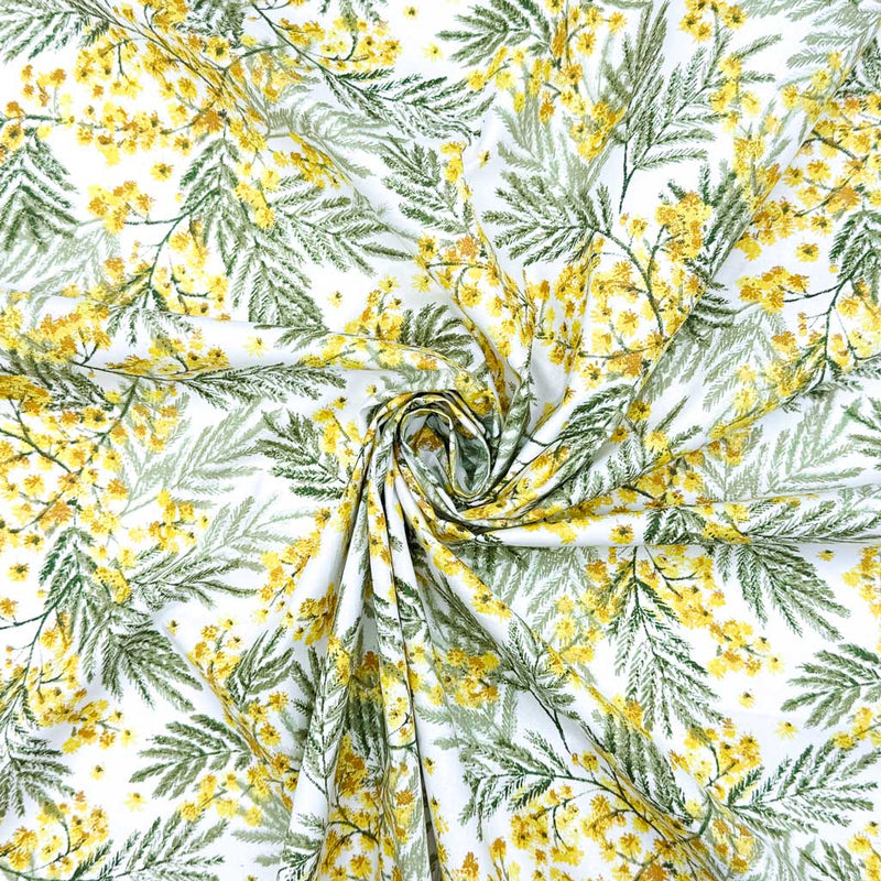 A detailed design of yellow wildflowers and delicate leaves; printed on a 100% cotton fabric