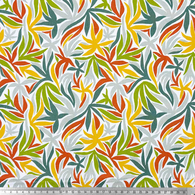 Multicoloured leaves on a contrasting white background; printed on a 100% cotton fabric with a cm ruler