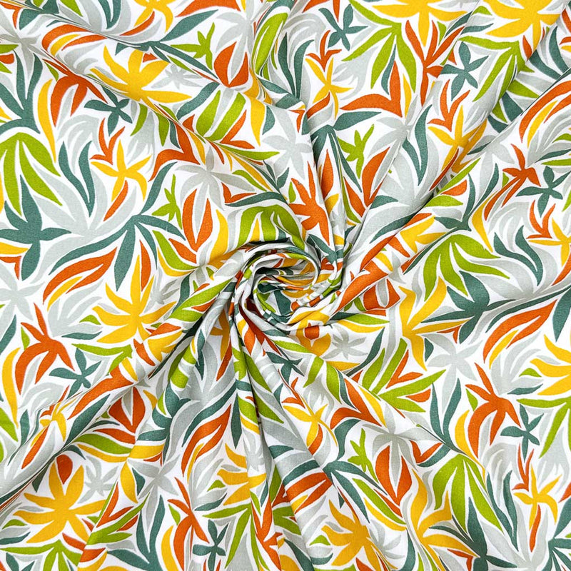 Multicoloured leaves on a contrasting white background; printed on a 100% cotton fabric