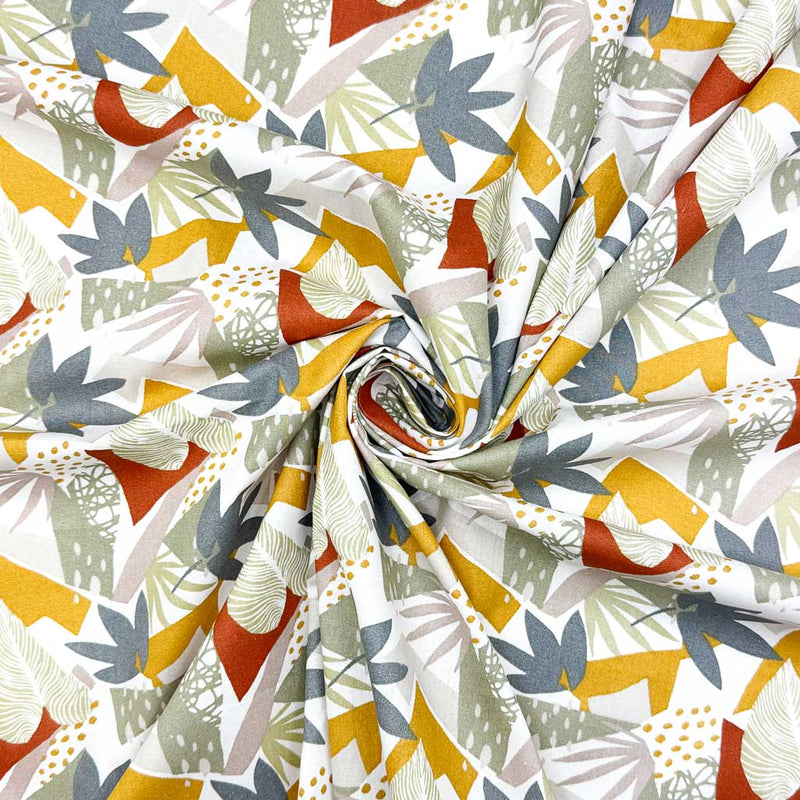 A bright, abstract design of leaves in bold red, blue and yellow on a contrasting background of greys; printed on a 100% cotton fabric