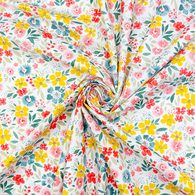A beautiful and colourful display of wild flowers in yellow, blue and pink printed on a 100% cotton fabric