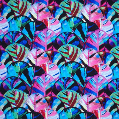 Leaves are printed on a french terry jersey fabric in vibrant blues and pinks