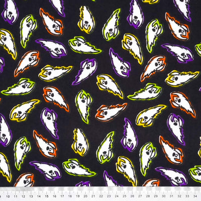 Vibrantly coloured flying ghosts are printed on a black polycotton fabric with a cm ruler
