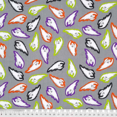 Vibrantly colourful flying ghosts are printed on a grey background with a cm ruler