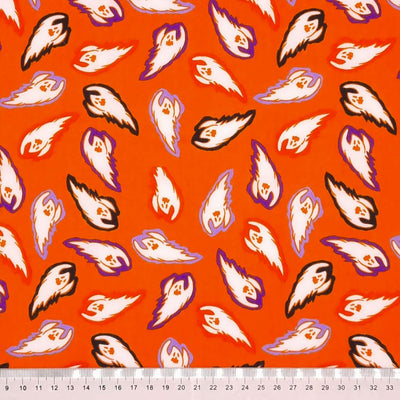 Vibrantly coloured flying ghosts are printed on an orange background with a cm ruler