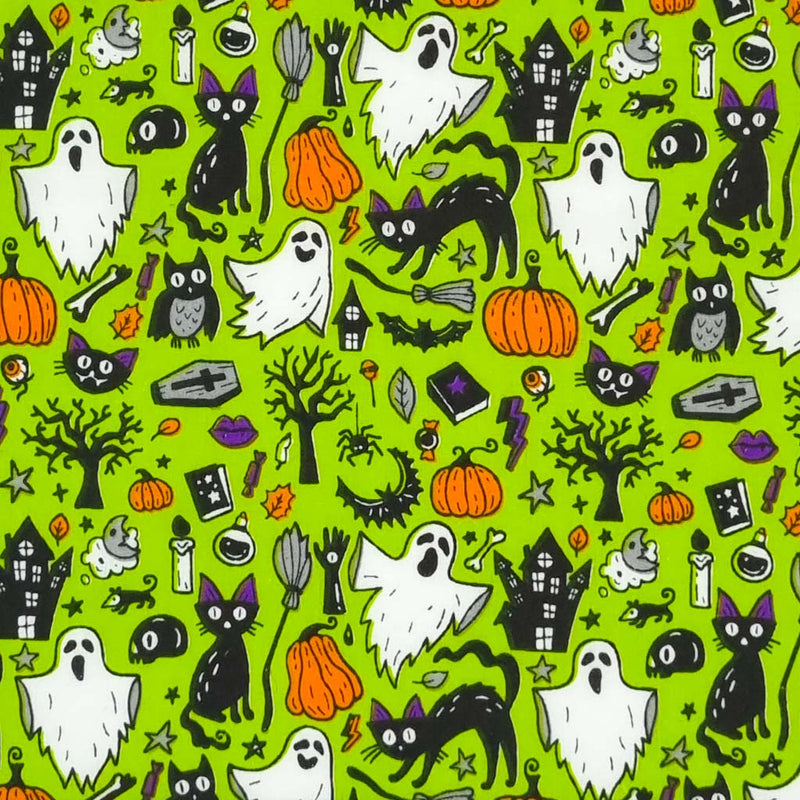 Ghosts, cats and pumpkins are printed on a green halloween polycotton fabric