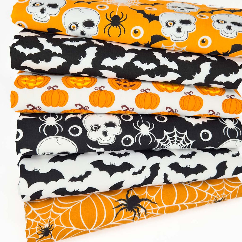 A black white and orange halloween fat quarter bundle with bats and pumpkins