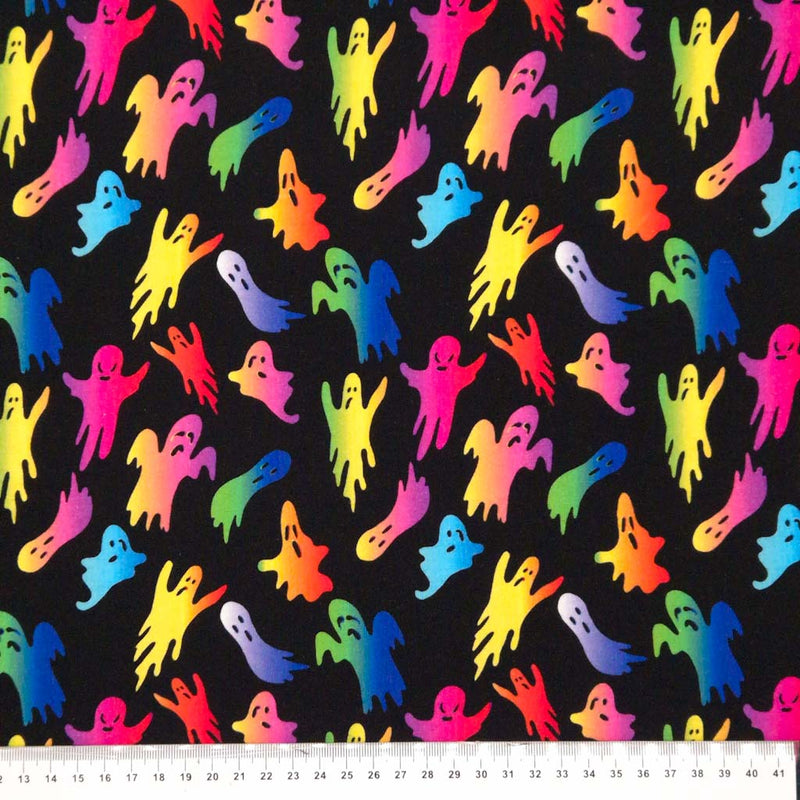 Neon coloured ghosts are printed on a black cotton jersey fabric with a cm ruler