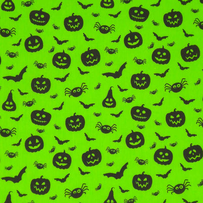 Halloween creatures printed on a neon green polycotton fabric