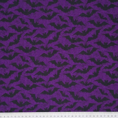 Black bats printed on a purple polycotton fabric