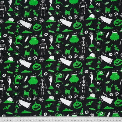 Green ghouls printed on a black halloween polycotton fabric