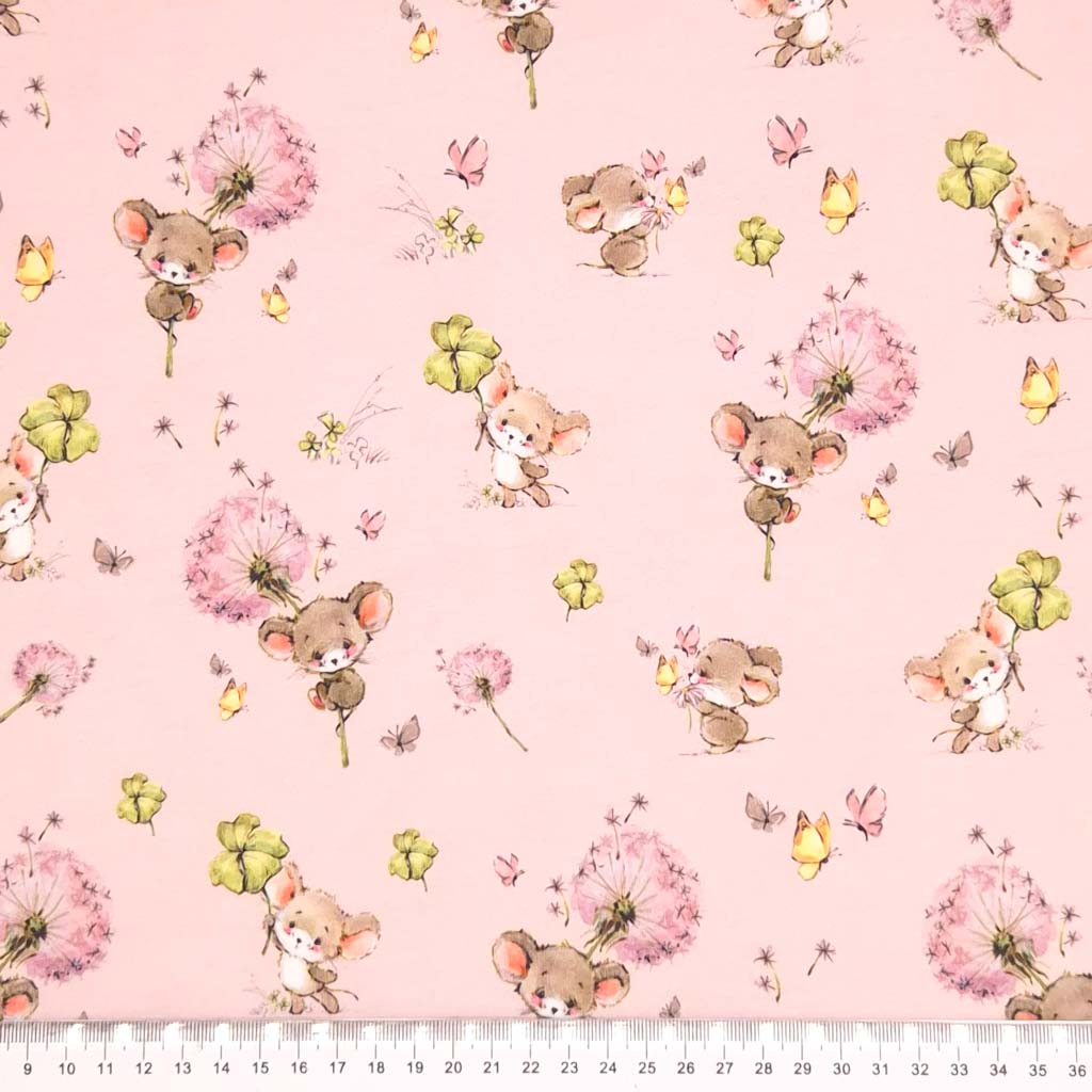 Cute mice holding clover printed on a pink cotton jersey fabric with a cm ruler
