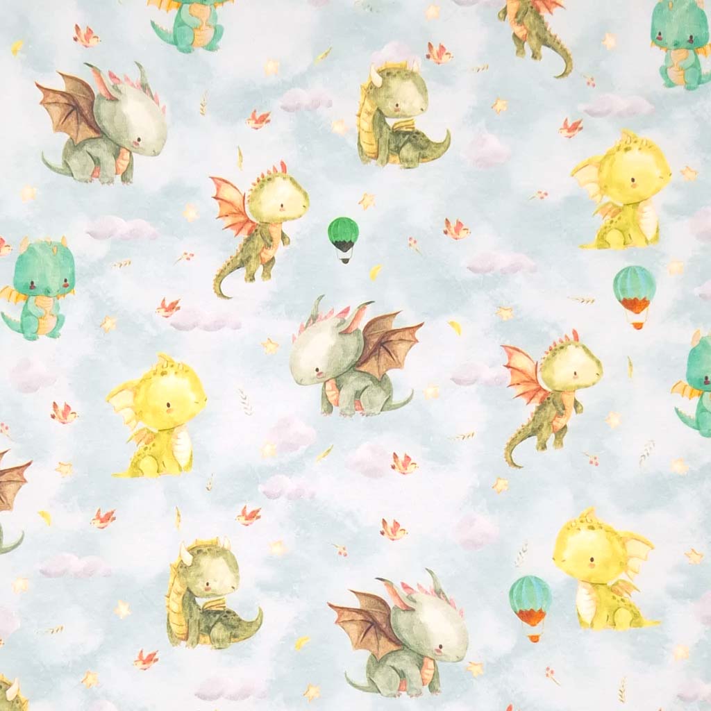 Cute dragons are printed on a pale blue cotton jersey fabric
